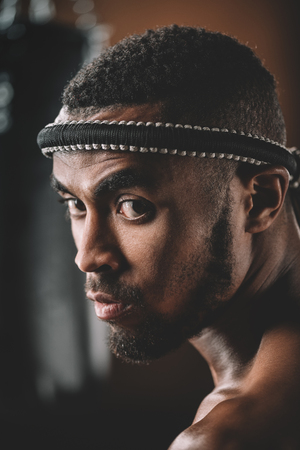confident muay thai fighter with mongkhon on headの写真素材