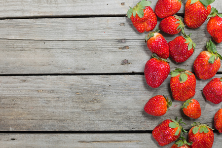 fresh red strawberries on wooden tabletop with copy space, berries background conceptの写真素材