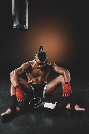 tired muay thai fighter with mongkhon on headの写真素材