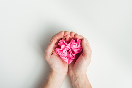 hands holding wrinkled papers isolated on whiteの写真素材