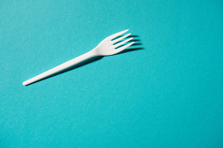 white plastic fork isolated on blueの写真素材