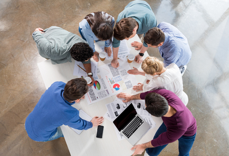 overhead view of professional businesspeople discussing and brainstorming togetherの写真素材