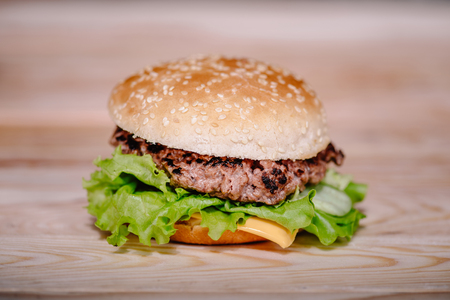 freshly cooked meat burger on wooden tabletopの写真素材