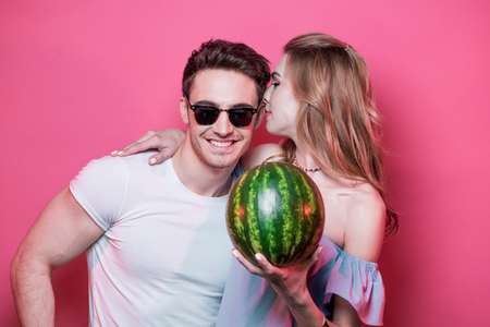 Stylish young couple in love posing with fresh ripe watermelonの写真素材