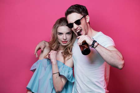 young stylish couple at casual clothes posing and fooling aroundの写真素材