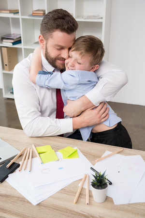 Businessman hugging with sonの写真素材