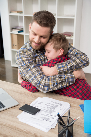 Father businessman hugs his sonの写真素材