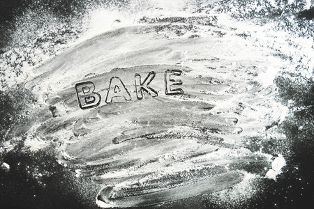 top view of baking forms stencil with flour on tabletop, baking cookiesの写真素材
