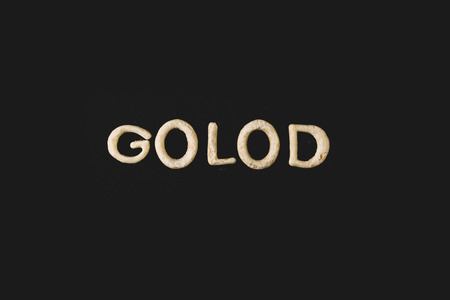 top view of word golod made from cookie dough isolated on blackの写真素材