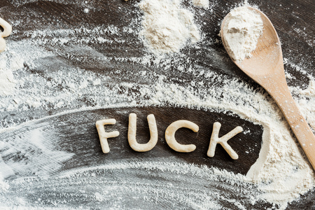 Top view of edible word fuck made from sweet crunchy cookies, baking cookies conceptの写真素材