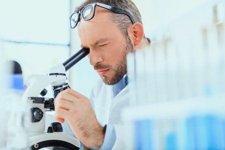 young doctor in uniform working at testing laboratory at clinicの写真素材