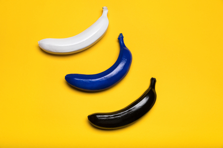 Top view of fresh colored bananas isolated on yellowの写真素材