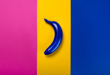 one whole blue colored banana on colorful backgroundの写真素材