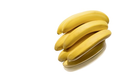 bunch of fresh ripe bananas isolated on whiteの写真素材