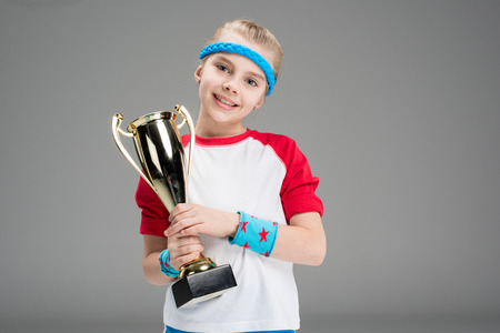 portrait of active girl holding champions gobletの写真素材