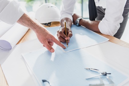 professional architects in formal wear working at modern officeの写真素材