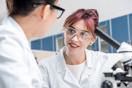 scientists working together with microscopes in chemical labの写真素材