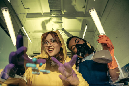 two young women chemists working at scientific laboratory with drugsの写真素材