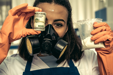young girl laboratory technician in personal protective equipmentの写真素材