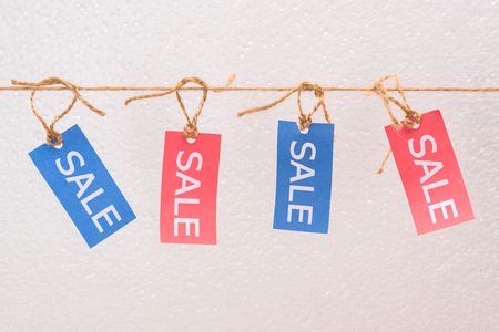 colorful sale tags hanging on rope, offer sale tagsの写真素材