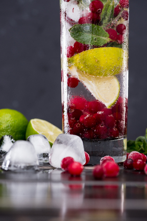 cranberry lemonade in glass with ice cubes, cocktail bar background conceptの写真素材
