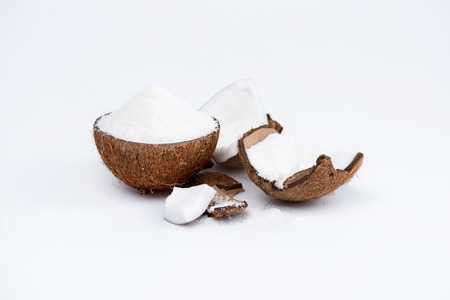 ripe organic coconut with sweet shavings isolated on whiteの写真素材