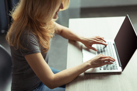 woman blogger working on laptop while sitting at homeの写真素材