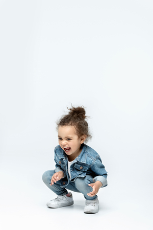 funny little kid girl in jeansの写真素材