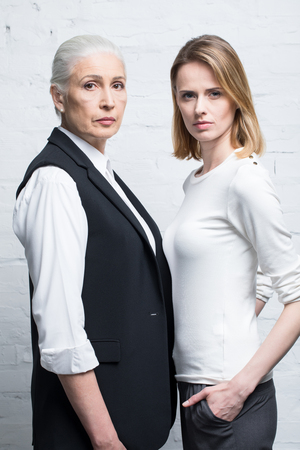 Portrait of serious women standing together and looking at cameraの写真素材