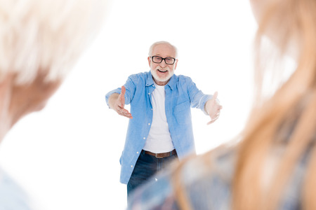 happy bearded grandfather ready to hug his familyの写真素材