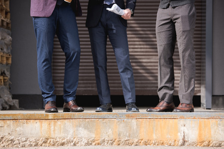 cropped shot of stylish businessmen in formalwear meeting outdoors at breakの写真素材