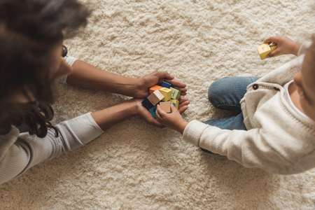 mother and little daughter playing with cubes togetherの写真素材