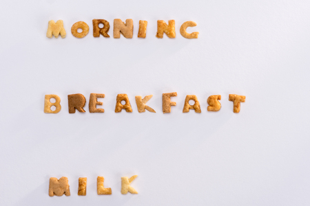 words morning, breakfast, milk from alphabet corn flakes isolated on greyの写真素材