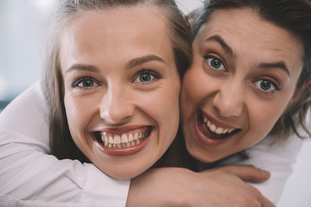 beautiful excited homosexual couple embracing and smilingの写真素材