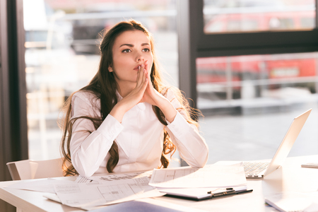 businesswoman sitting at workplace with laptop in modern officeの写真素材