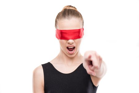 gymnast in leotard with eyes covered with red ribbon yelling and gesturingの写真素材