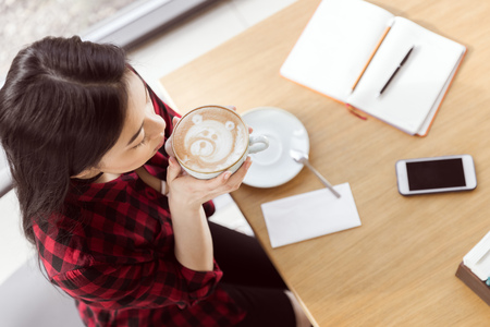 asian girl drinking coffee in cafe, coffee break conceptの写真素材