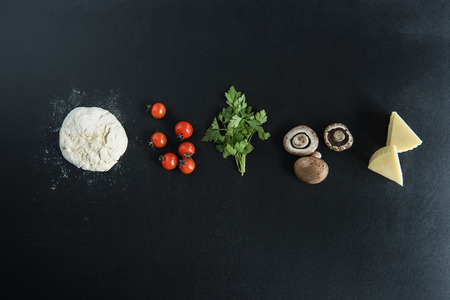 top view of dough with ingredients for preparing italian pizzaの素材 [FY31081076802]