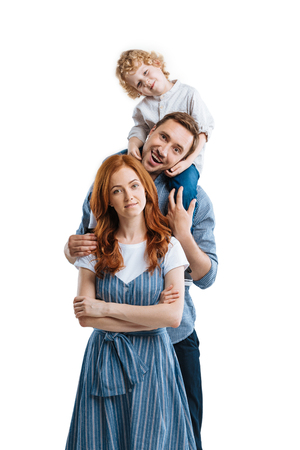 Happy family with one child hugging and smiling at cameraの写真素材