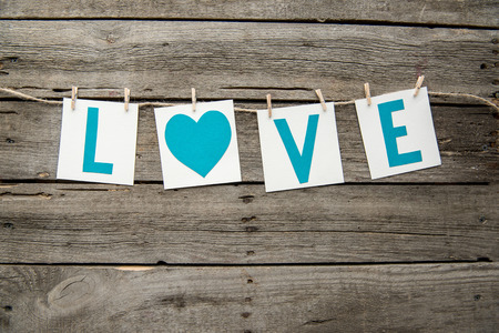 Handmade decoration with love sign lying on wooden tableの写真素材