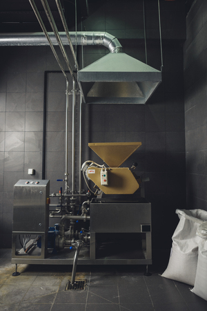 Industrial equipment with bags of grains at breweryの写真素材