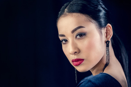 beautiful asian woman with makeup looking at cameraの写真素材