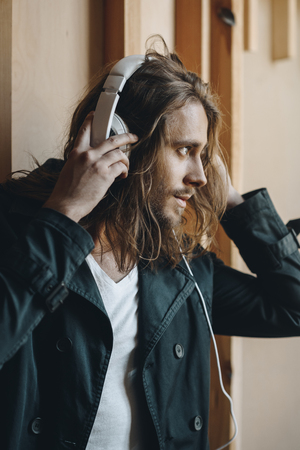 handsome stylish young man listening music in headphonesの写真素材