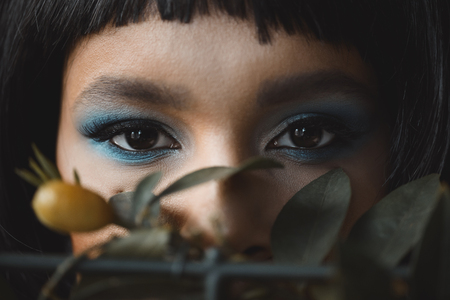 woman with bright makeup looking at cameraの写真素材