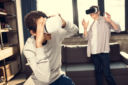 teenage boys wearing virtual reality headsets at home