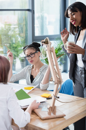 young businesswomen working together in modern office and discussingの写真素材