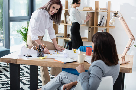 young businesswomen working together in modern office and discussingの写真素材