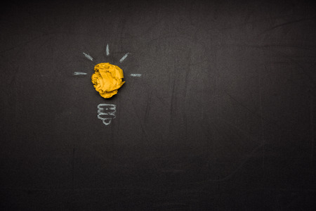 light bulb symbol made of crumpled paperの写真素材