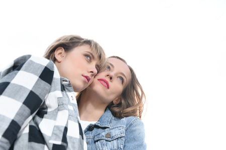 casual homosexual couple looking away isolated on whiteの写真素材