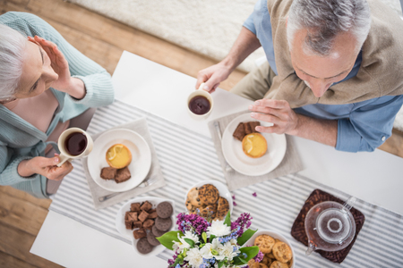 senior couple having breakfast at homeの写真素材